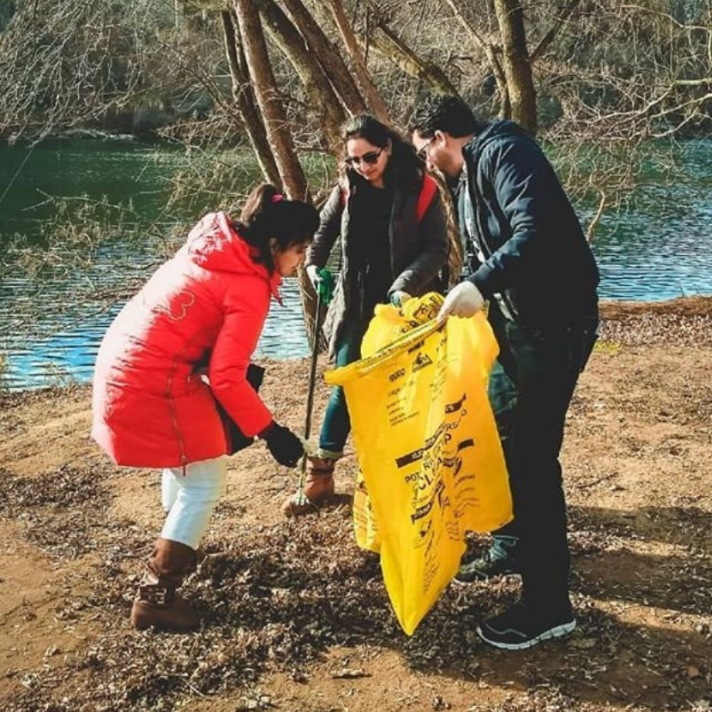 People cleaning up near river