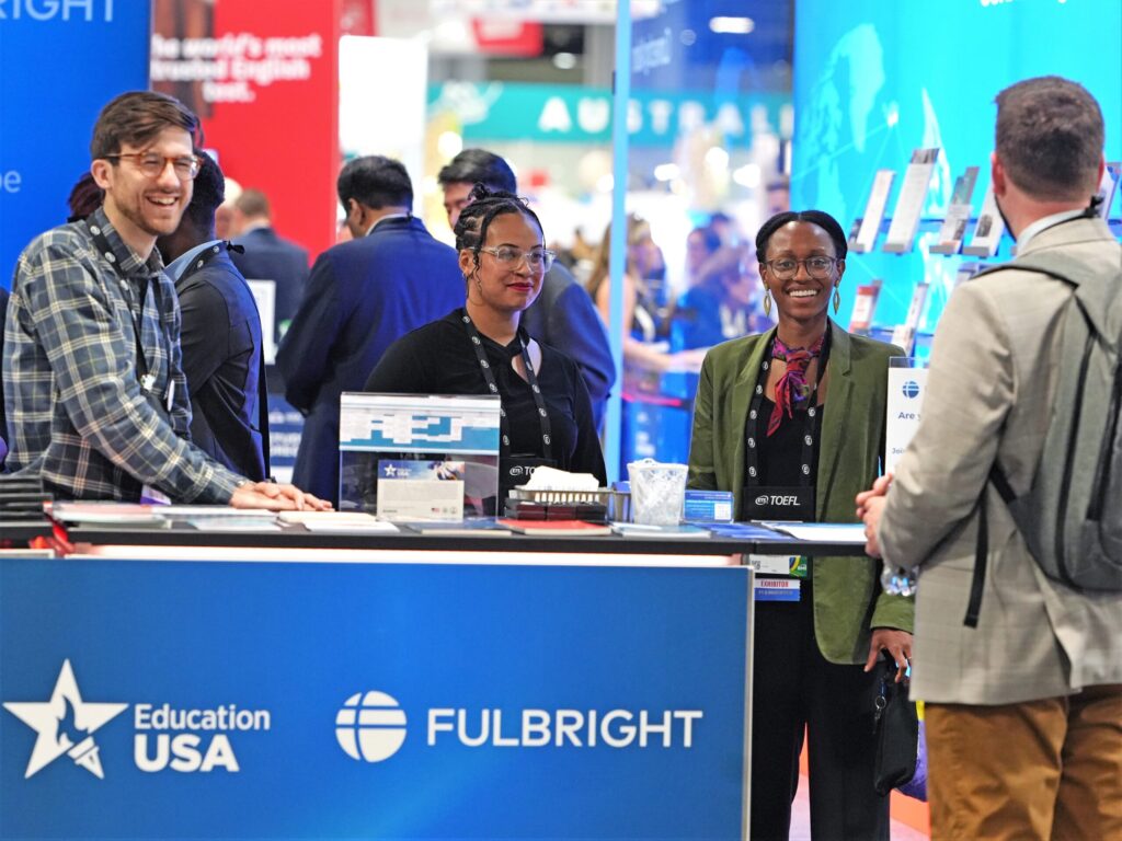 Group of people at conference booth.