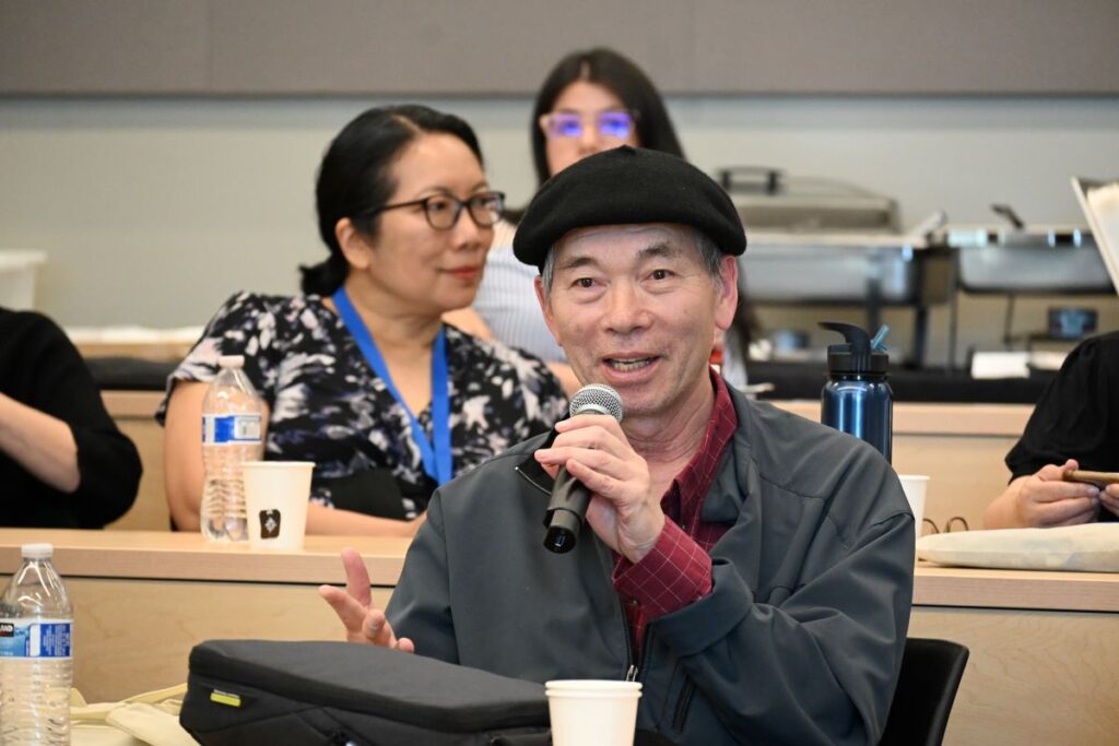 Fulbright Scholar Liaison speaking and holding microphone