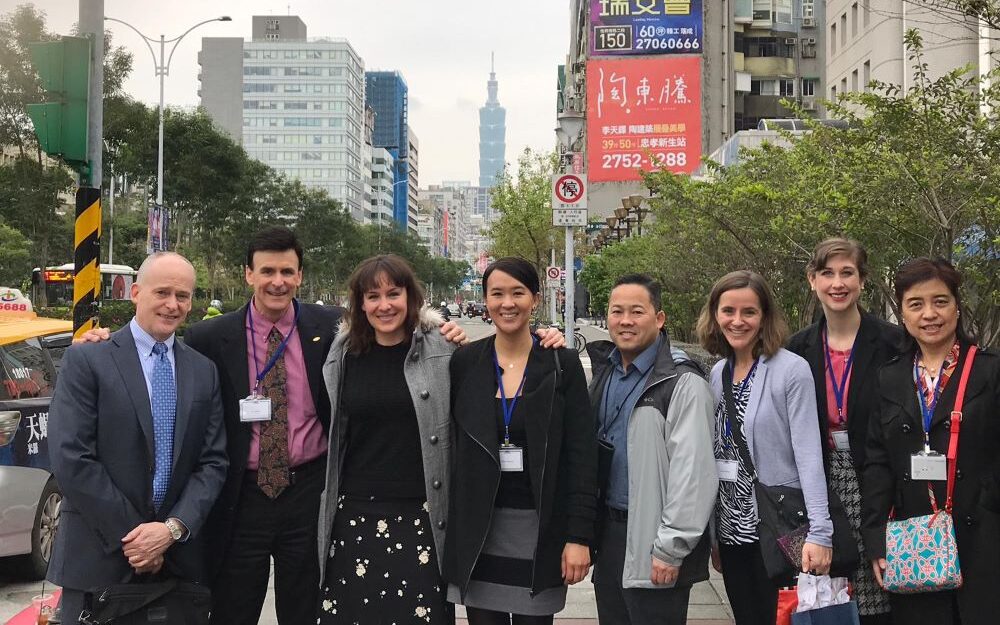 Charles Sasaki with group standing on city street in Taiwan