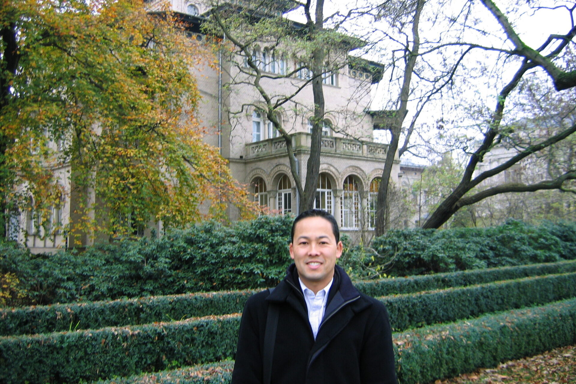 Charles Sasaki standing in front of large building taking part in Fulbright IEA seminar in Germany