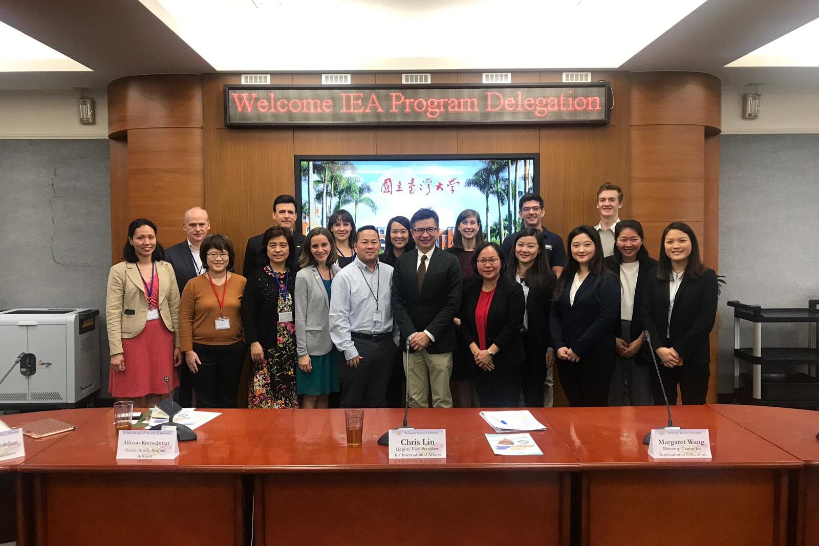 Charles Sasaki and group standing in front of screen taking part in Fulbright IEA seminar in Taiwan