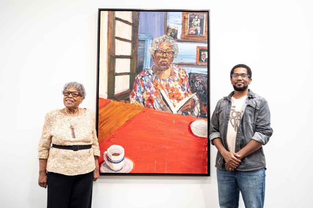Sedrick Huckaby and Opal Lee standing on either side of painting
