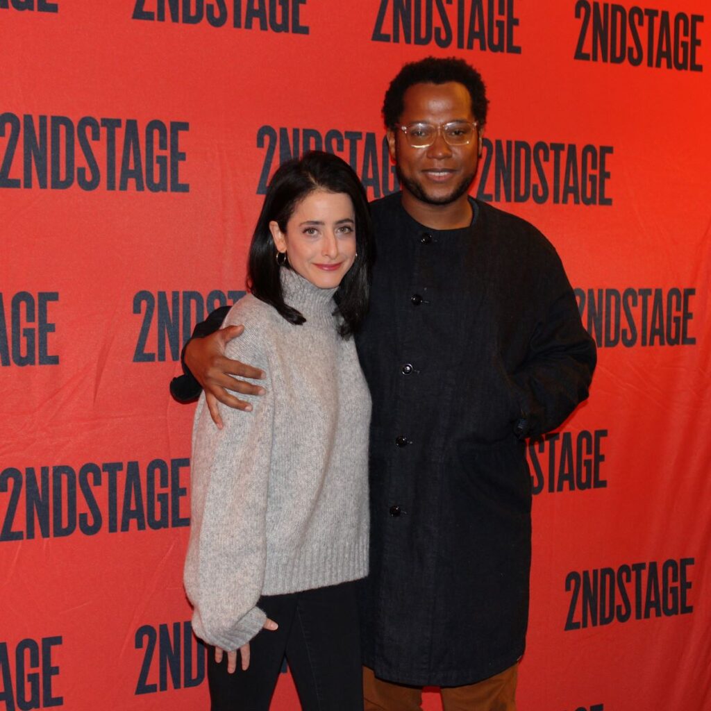 Branden Jacobs-Jenkins with arm around Lila Neugebauer in front of 2ndStage step and repeat sign