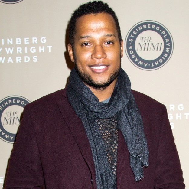 Branden Jacobs-Jenkins standing at Steinberg Awards in front of step and repeat