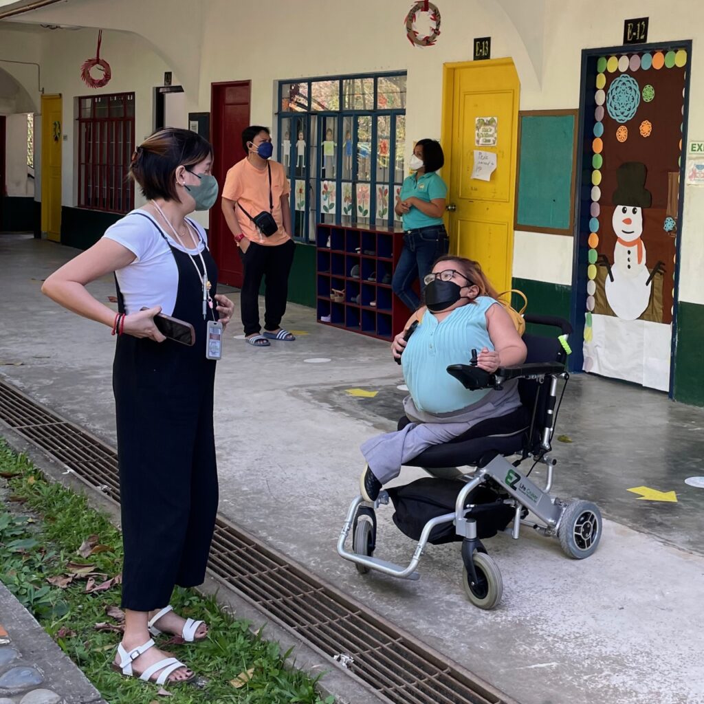 Olivia Mae Asuncion talking with colleague at the Cavite Institute