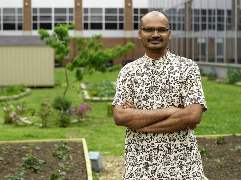 Dr. Karuppusamy standing in garden