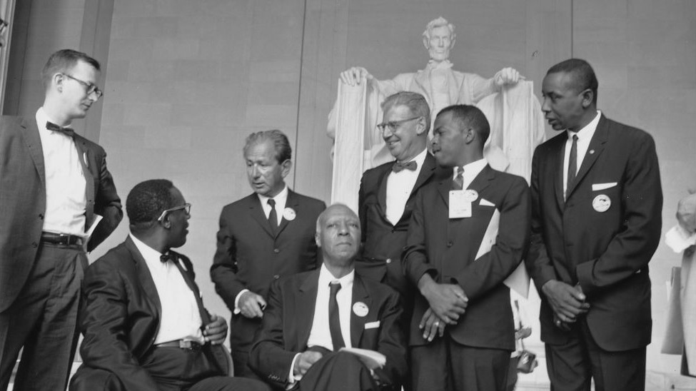 John Lewis with sitting with members from Student Nonviolent Coordinating Committee in front of Lincoln Memorial in Washington DC.