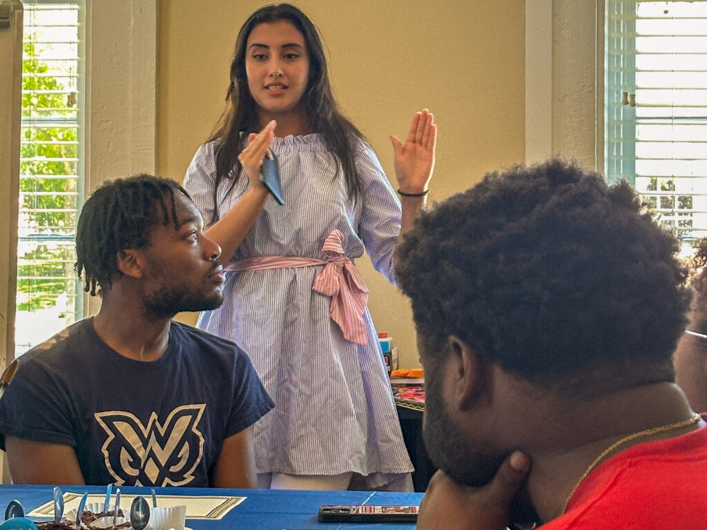 Selma Sebbane standing up in classroom teaching two students sitting at tables