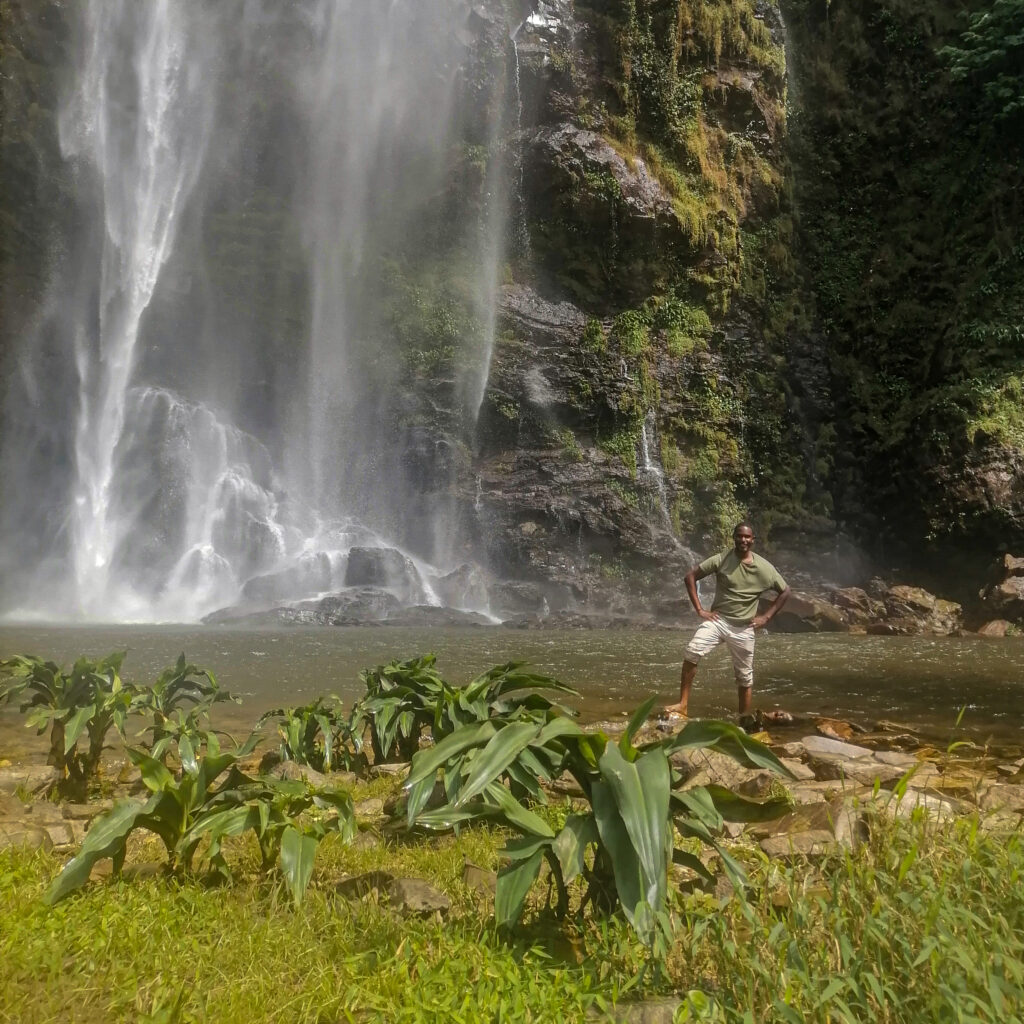 Karl Jackson standing by Wli fall on Ghana-Togo border