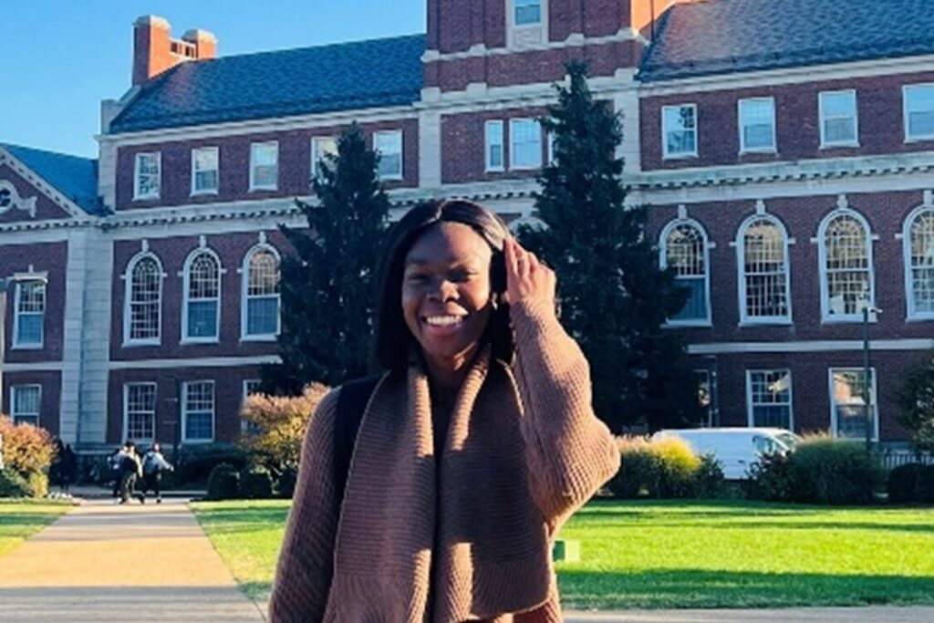 Dr. Addadzi-Koom standing in front of Howard University building