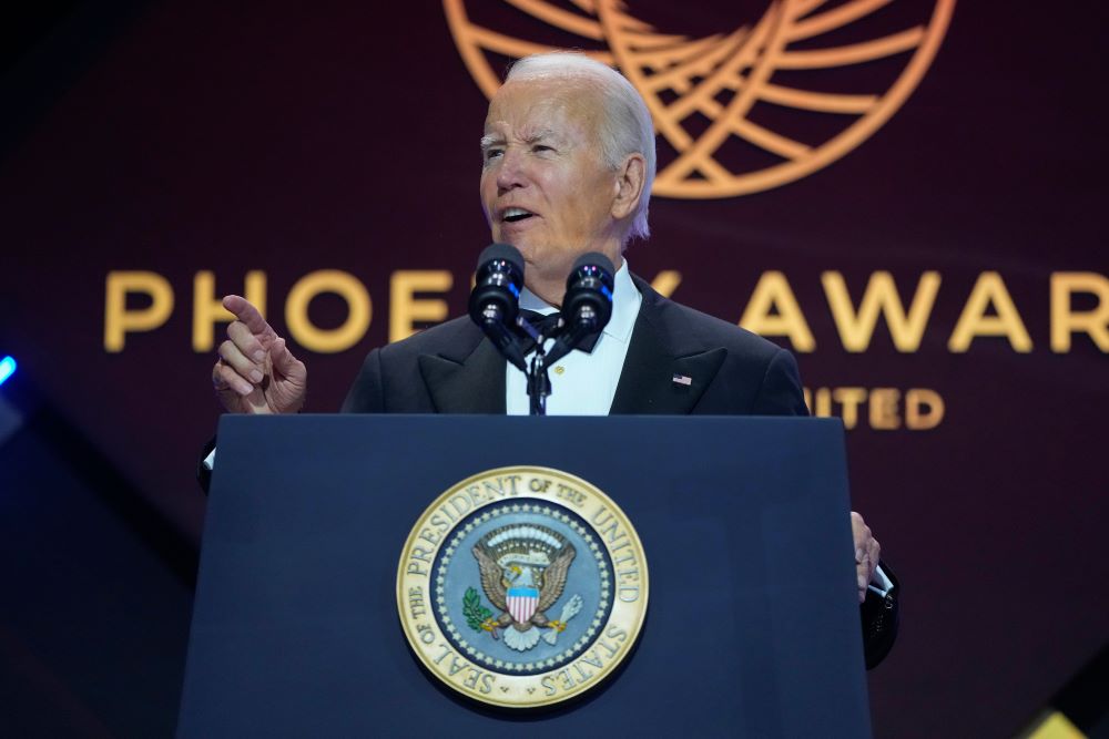 President Biden standing at podium speaking at awards dinner.