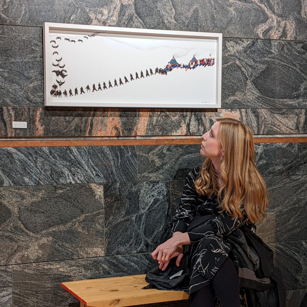 Woman sitting in front of sign