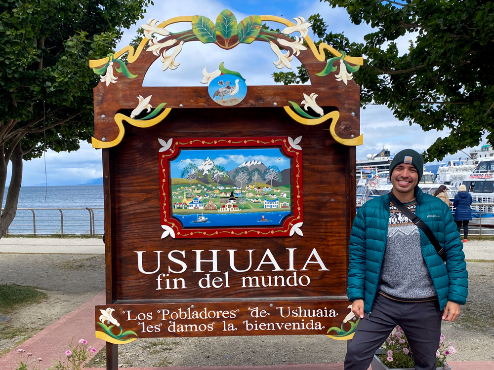 Juan Gonzalez standing next to sign Ushuaia sign