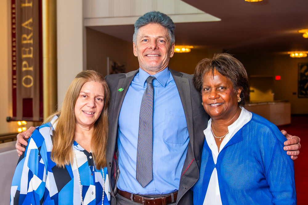 Gilda Almeida and Alicia Adams standing with Kennedy Fellow Eder Zanetti at Kennedy Center