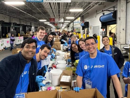 Juan Gonzalez with other Fulbrighters filling boxes