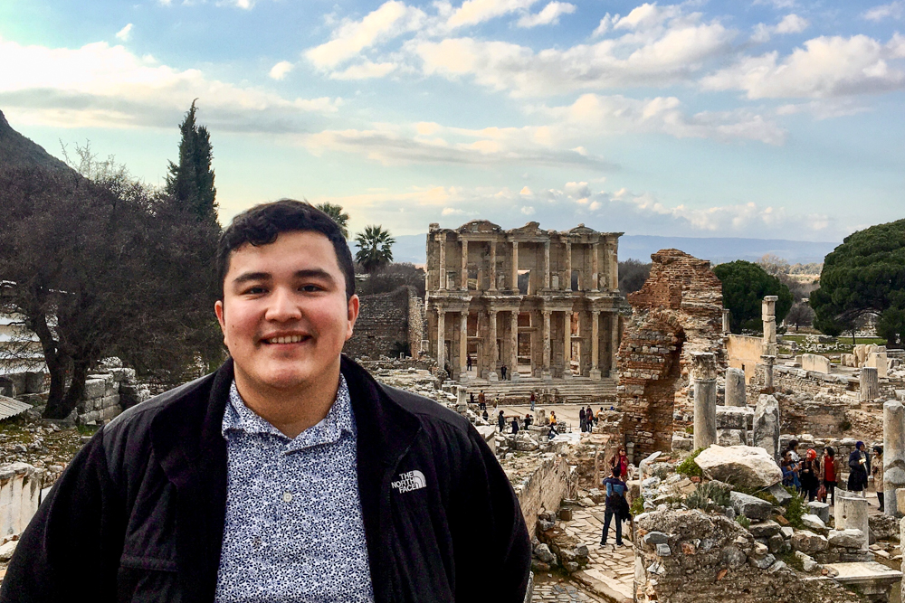 Johnny Zapata standing in front of ruins in Turkey