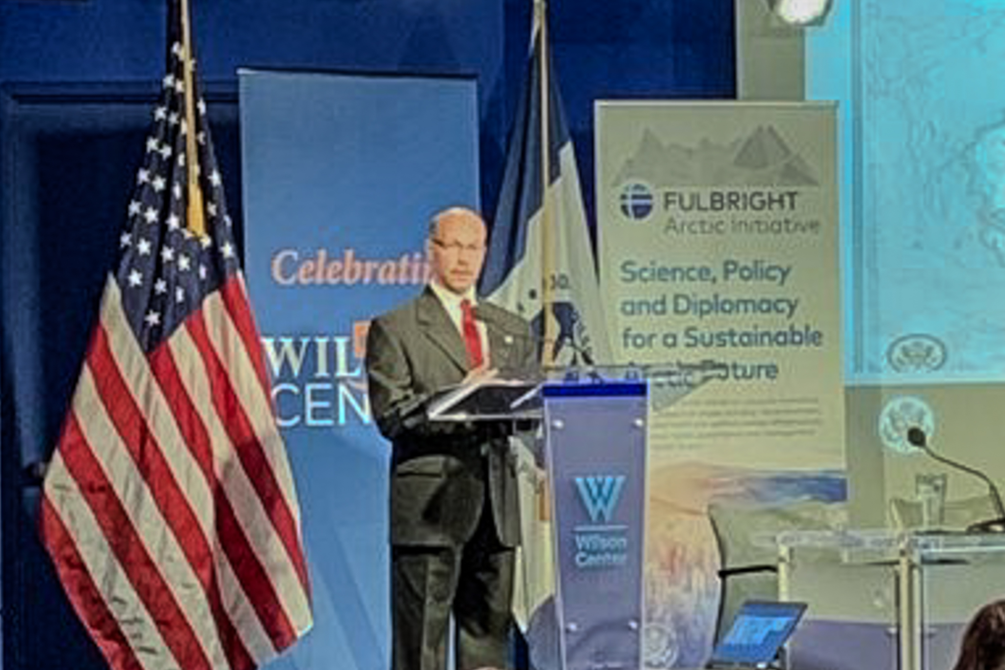 Dr. Michael Sfraga standing at podium speaking at Wilson Center