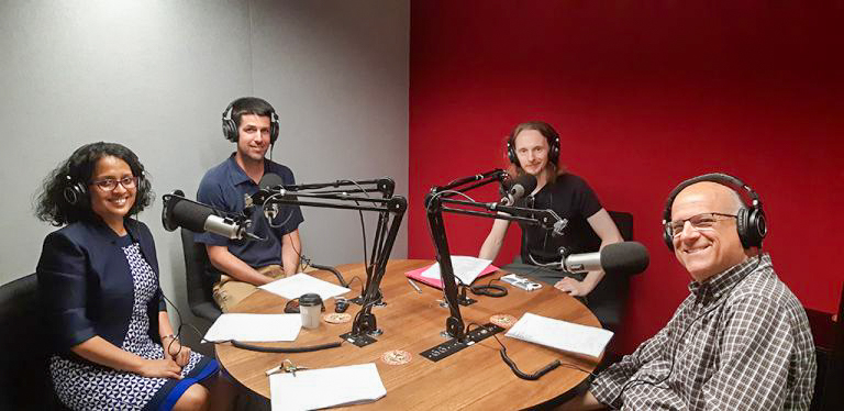 Fulbrighter and students sitting around table with recording equipment