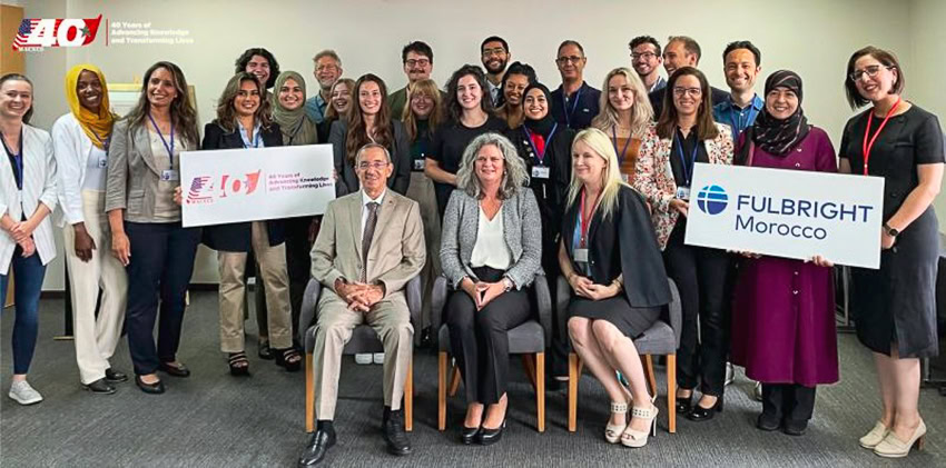 A group photo of people posing with "FULBRIGHT Morocco" and "40 Years" signs.