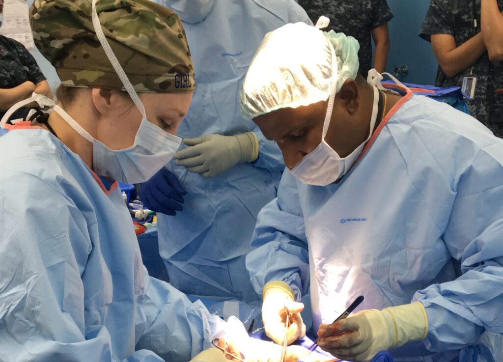 Dr. Worlton performing surgery with Sri Lankan doctor