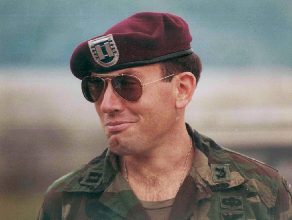 Man wearting a U.S. Army uniform with sunglasses and a maroon beret 